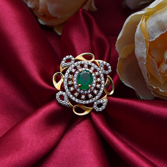 "gold ring with a radiant green gemstone and dazzling diamonds, designed to make a bold and sophisticated statement."