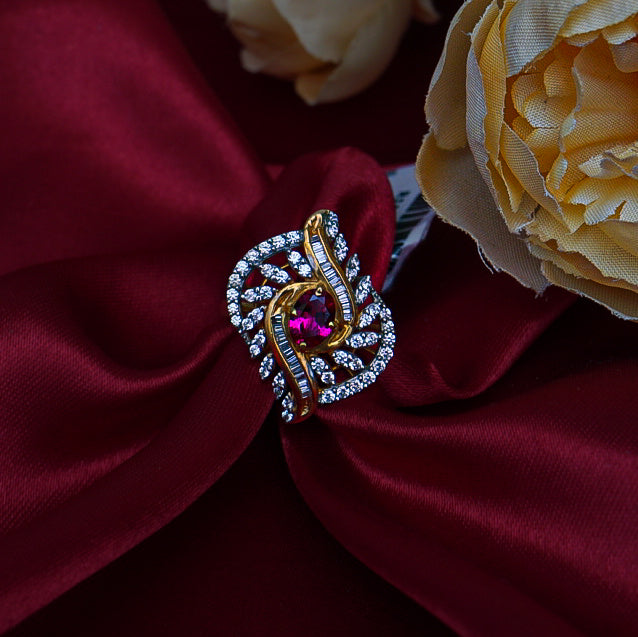 "A striking gold ring with brilliant diamonds surrounding a bold red gemstone at its heart.