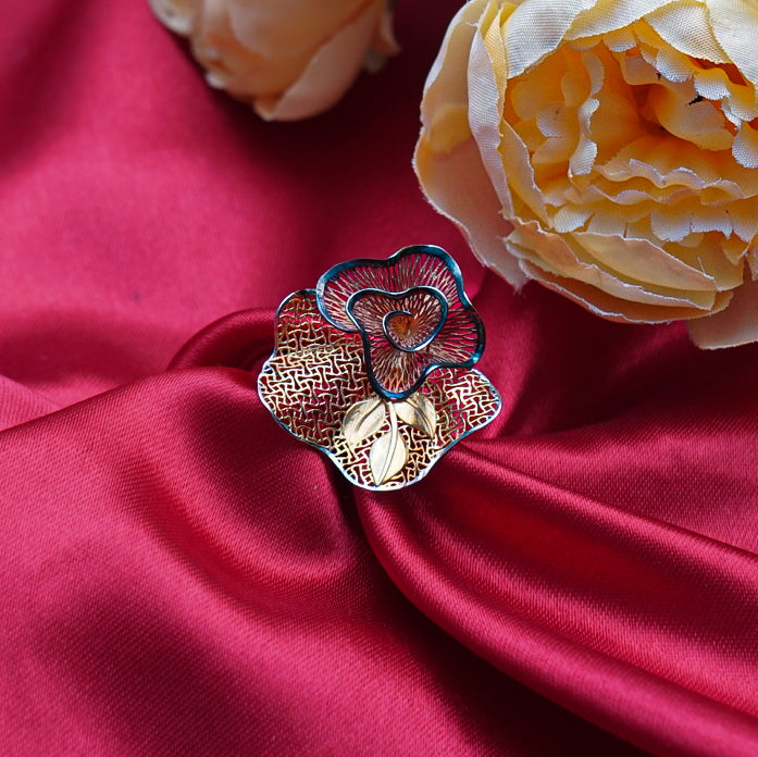 Gold ring featuring a unique floral design with intricate details.