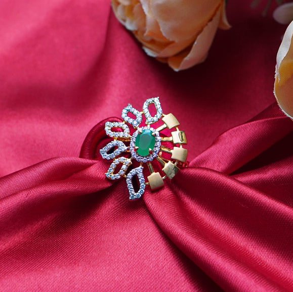 "A luxurious gold ring with a vibrant green gemstone and diamond accents".