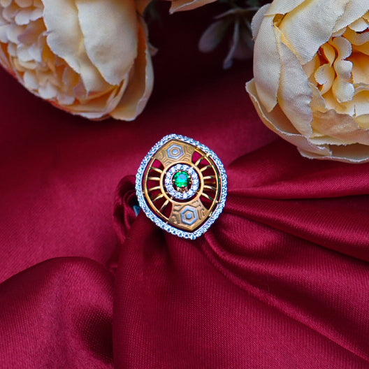 "An elegant and one-of-a-kind gold ring featuring a captivating green gemstone at its center.