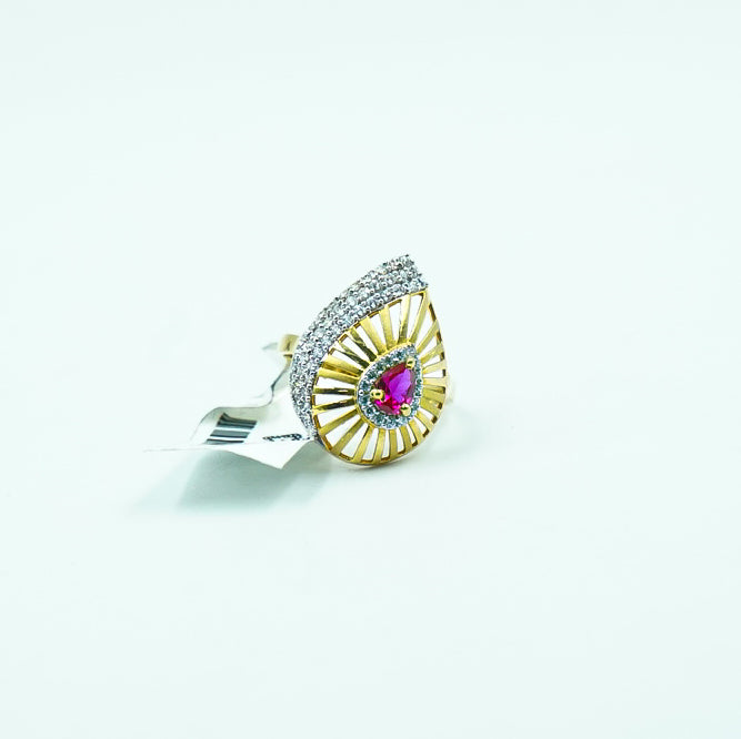 exquisite gold ring features a fiery red gemstone at its core, surrounded by sparkling diamonds.