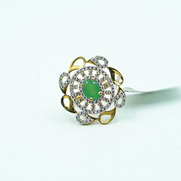 "gold ring with a radiant green gemstone and dazzling diamonds, designed to make a bold and sophisticated statement."