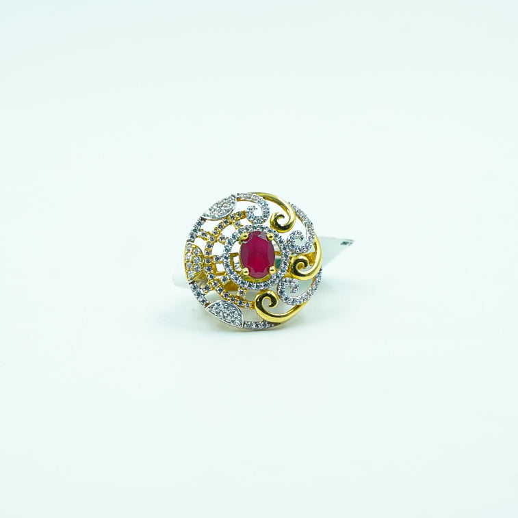 "A classic round gold ring with a captivating red gemstone at its center, surrounded by shimmering diamonds.