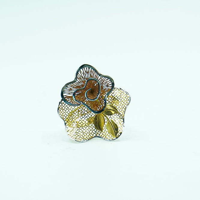 Gold ring featuring a unique floral design with intricate details.