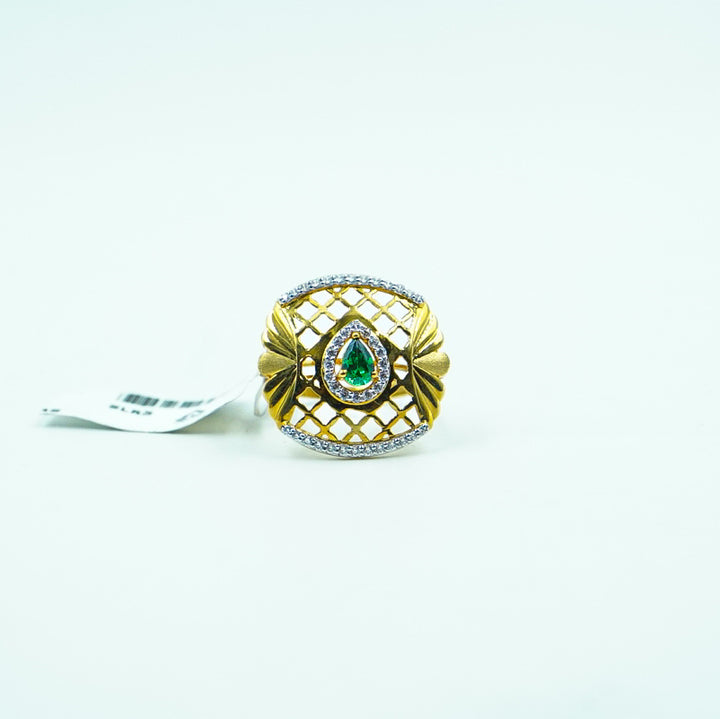 "This gold ring, featuring a rich green gemstone framed by shimmering diamonds."