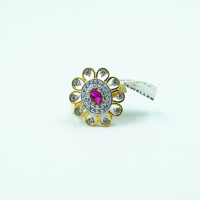 "round gold ring, featuring a bold red gemstone surrounded by dazzling diamonds.