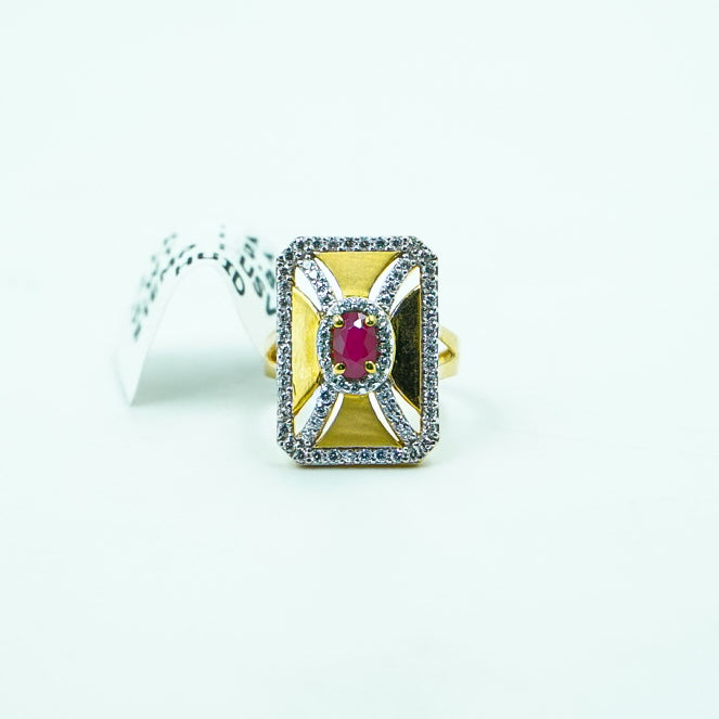 "This square gold ring with a fiery red gemstone and diamonds combines geometric elegance.