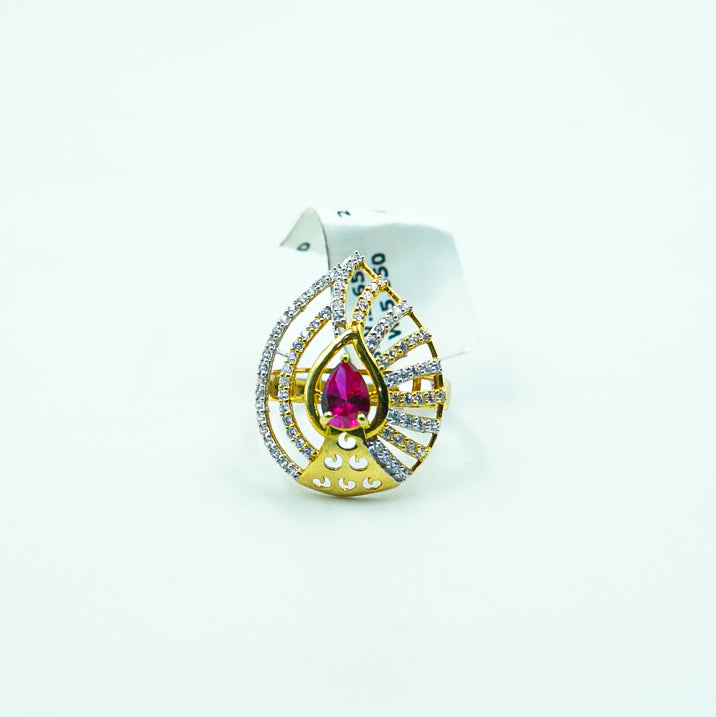 "An exquisite petal-shaped gold ring with a vibrant red gemstone at its center.